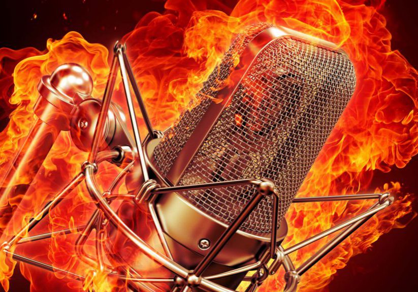 microphone is on fire - professional microphone on a black background lit by fire